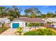 Inviting one-story home with blue garage door and lush landscaping enhancing curb appeal at 5529 11Th N Ave, St Petersburg, FL 33710