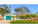 Charming single-story home with a well-manicured lawn and colorful tropical landscaping at 5529 11Th N Ave, St Petersburg, FL 33710
