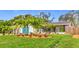 Landscaped front yard with palm trees and geometric driveway at 5529 11Th N Ave, St Petersburg, FL 33710