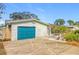 Teal garage door and stone facade at 5529 11Th N Ave, St Petersburg, FL 33710