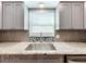 Modern kitchen with gray cabinets, granite countertops, and stainless steel appliances at 5529 11Th N Ave, St Petersburg, FL 33710