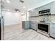 Modern kitchen with gray cabinets, granite countertops, and stainless steel appliances at 5529 11Th N Ave, St Petersburg, FL 33710