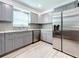 Modern kitchen with gray cabinets, granite countertops, and stainless steel appliances at 5529 11Th N Ave, St Petersburg, FL 33710