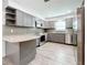 Updated kitchen featuring gray cabinets, granite countertops, and stainless steel appliances at 5529 11Th N Ave, St Petersburg, FL 33710
