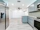 Modern kitchen with gray cabinets, granite countertops, and stainless steel appliances at 5529 11Th N Ave, St Petersburg, FL 33710