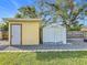 Two-shed storage in backyard, tan and white at 5529 11Th N Ave, St Petersburg, FL 33710
