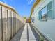 Side yard with gravel pathway and wooden fence at 5529 11Th N Ave, St Petersburg, FL 33710