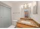 Bathroom with granite countertop and sliding glass shower at 8701 Blind Pass Rd # 306B, St Pete Beach, FL 33706
