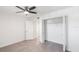 Bright bedroom with ceiling fan and walk-in closet at 8701 Blind Pass Rd # 306B, St Pete Beach, FL 33706