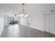 Bright dining room with tiled floors and sliding glass doors to balcony at 8701 Blind Pass Rd # 306B, St Pete Beach, FL 33706