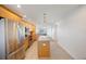 Modern kitchen with stainless steel appliances and light wood cabinets at 8701 Blind Pass Rd # 306B, St Pete Beach, FL 33706