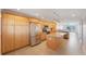 Kitchen with island, stainless steel appliances, and light wood cabinets at 8701 Blind Pass Rd # 306B, St Pete Beach, FL 33706