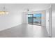 Bright living room with water view and sliding glass doors at 8701 Blind Pass Rd # 306B, St Pete Beach, FL 33706