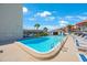 Community pool area with surrounding lounge chairs at 8701 Blind Pass Rd # 306B, St Pete Beach, FL 33706