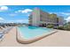 Refreshing community pool with lounge chairs at 8701 Blind Pass Rd # 306B, St Pete Beach, FL 33706