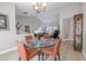 Inviting dining space with a glass table and views of the living room with an elegant chandelier at 1000 Chillum Ct, Safety Harbor, FL 34695