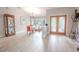 Bright dining area with wood floors, stylish chandelier, and ornate glass paneled doors at 1000 Chillum Ct, Safety Harbor, FL 34695