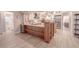 Large kitchen island features a wine fridge, bar seating, granite countertops, and custom cabinets at 1000 Chillum Ct, Safety Harbor, FL 34695
