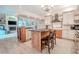 Gourmet kitchen featuring a center island, modern appliances, and wood-style tile flooring at 1000 Chillum Ct, Safety Harbor, FL 34695