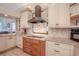 Stylish kitchen featuring custom cabinetry, granite countertops, and stainless steel appliances at 1000 Chillum Ct, Safety Harbor, FL 34695