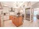 Elegant kitchen featuring a granite island, stainless steel appliances, and custom cabinetry at 1000 Chillum Ct, Safety Harbor, FL 34695