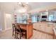Open kitchen features a bar with granite countertops and views into the living room at 1000 Chillum Ct, Safety Harbor, FL 34695