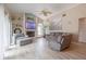 Inviting living room with a fireplace, built-in shelving, and a large painting with vaulted ceiling and fan at 1000 Chillum Ct, Safety Harbor, FL 34695