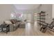 Comfortable living room with wood-look floors, neutral decor, and shelving unit offering ample storage space at 1000 Chillum Ct, Safety Harbor, FL 34695