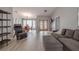 Open-concept living room and dining area featuring wood-look tile flooring, neutral paint, and lots of natural light at 1000 Chillum Ct, Safety Harbor, FL 34695