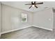 Bright bedroom with window, ceiling fan and wood-look floor at 11650 County Road 579 Hwy, Thonotosassa, FL 33592