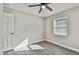 Well-lit bedroom featuring a ceiling fan and large window at 11650 County Road 579 Hwy, Thonotosassa, FL 33592