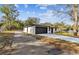Modern home with dark brown garage door and white exterior at 11650 County Road 579 Hwy, Thonotosassa, FL 33592