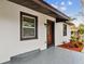 Modern front door with dark brown frame and gray step at 11650 County Road 579 Hwy, Thonotosassa, FL 33592