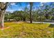 Landscaped front yard with mature trees at 11650 County Road 579 Hwy, Thonotosassa, FL 33592