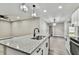 Modern kitchen with white cabinetry and a spacious island at 11650 County Road 579 Hwy, Thonotosassa, FL 33592