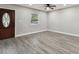 Spacious living room with gray vinyl plank flooring and ceiling fan at 11650 County Road 579 Hwy, Thonotosassa, FL 33592