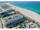 Aerial view of beachfront condo building with pool and parking at 12000 Gulf Blvd # 309N, Treasure Island, FL 33706