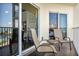 Private balcony with patio furniture and ocean view at 12000 Gulf Blvd # 309N, Treasure Island, FL 33706