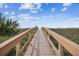 Wooden boardwalk leads to sandy beach at 12000 Gulf Blvd # 309N, Treasure Island, FL 33706