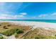 Stunning view of a pristine beach with boardwalk access from the property at 12000 Gulf Blvd # 309N, Treasure Island, FL 33706