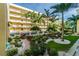 Lush courtyard with tropical landscaping, walking paths, and building views at 12000 Gulf Blvd # 309N, Treasure Island, FL 33706