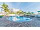 Inviting resort-style pool with comfortable seating and umbrellas at 12000 Gulf Blvd # 309N, Treasure Island, FL 33706