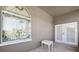 Covered balcony featuring stained glass window, white double doors, and patio table at 1388 Brightwaters Ne Blvd, St Petersburg, FL 33704