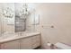 A bathroom featuring a vanity, toilet, decorative chandelier, and shower with tub at 1388 Brightwaters Ne Blvd, St Petersburg, FL 33704