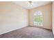 This bedroom features a ceiling fan and a window with plantation shutters at 1388 Brightwaters Ne Blvd, St Petersburg, FL 33704