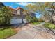 Side view of house showcasing garage and landscaping at 1388 Brightwaters Ne Blvd, St Petersburg, FL 33704
