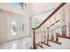 Welcoming foyer with tiled floors, staircase, and decorative glass double doors at 1388 Brightwaters Ne Blvd, St Petersburg, FL 33704
