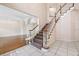 Bright foyer featuring arched entryways, elegant staircase, and tile flooring at 1388 Brightwaters Ne Blvd, St Petersburg, FL 33704