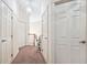 A carpeted hallway with multiple doors and a stairlift system visible at 1388 Brightwaters Ne Blvd, St Petersburg, FL 33704