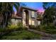 Two-story house exterior at dusk, beautifully lit at 1388 Brightwaters Ne Blvd, St Petersburg, FL 33704